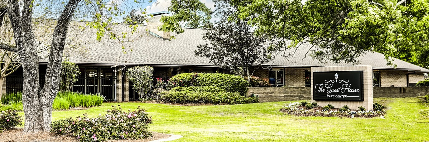Exterior view of a senior living facility with landscaped gardens