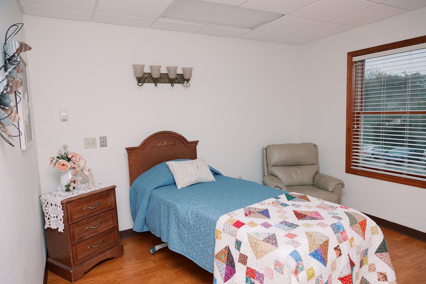 Private resident room with a bed and chair