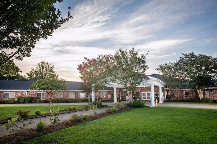 Exterior view of a nursing home with landscaped gardens