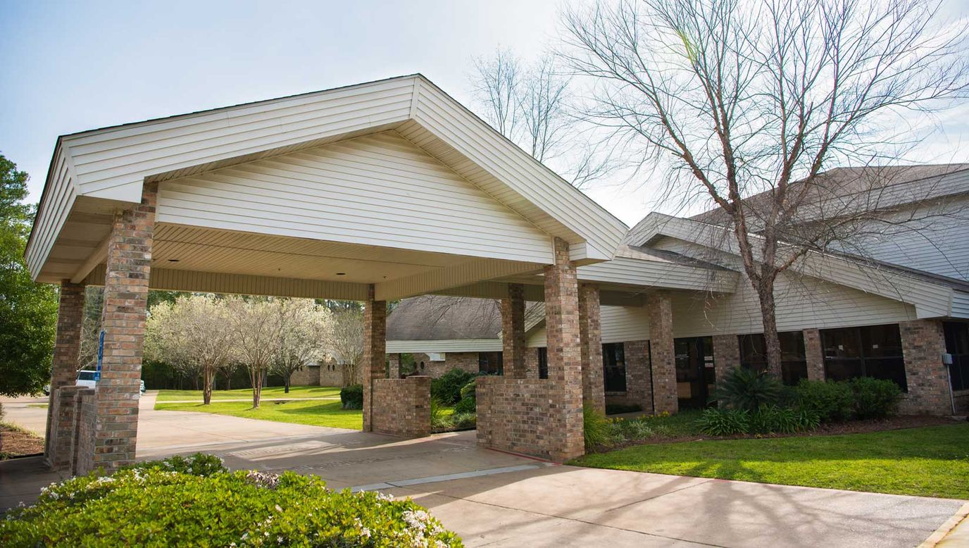Entrance of a senior living facility with a covered awning