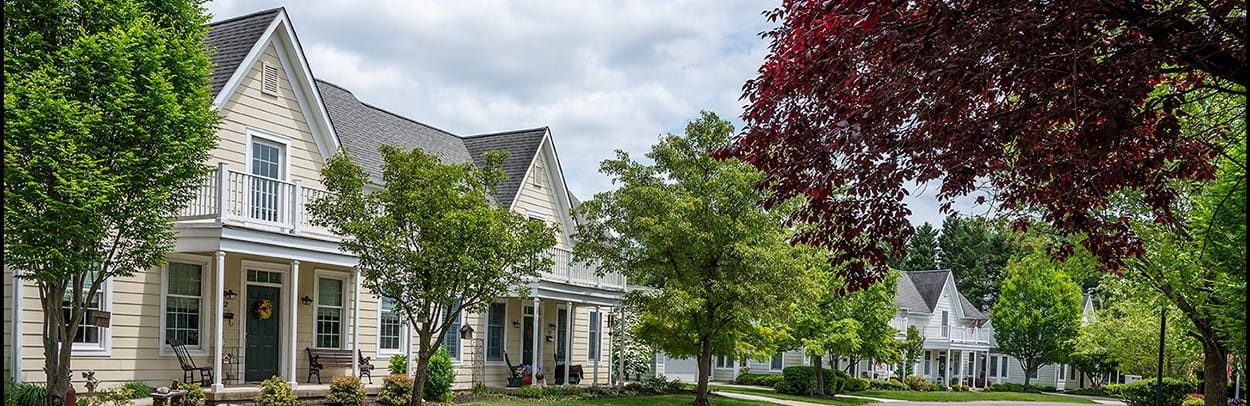 Exterior view of residential cottages with trees