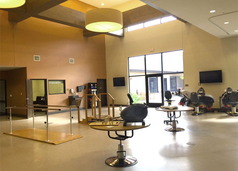 A bright therapy room with exercise equipment