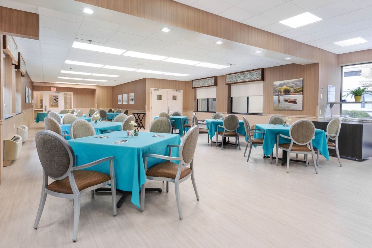 Bright dining room with teal tables and chairs