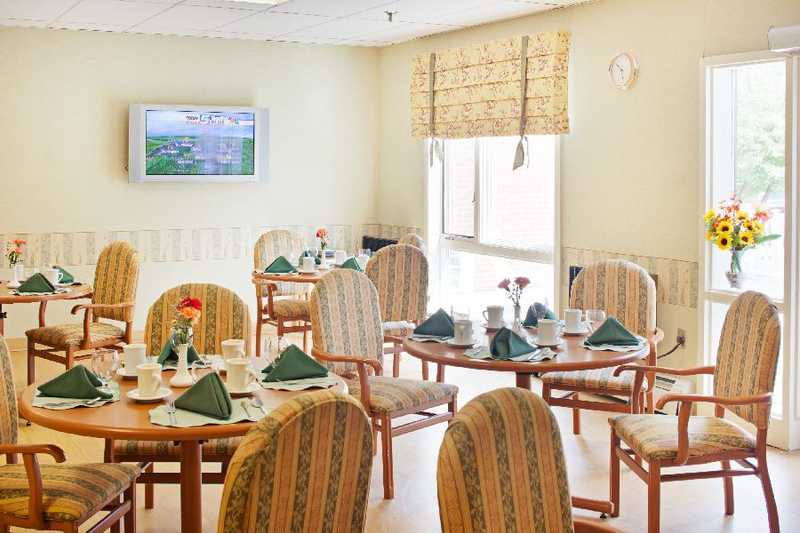 Dining room set for a meal with flowers on tables