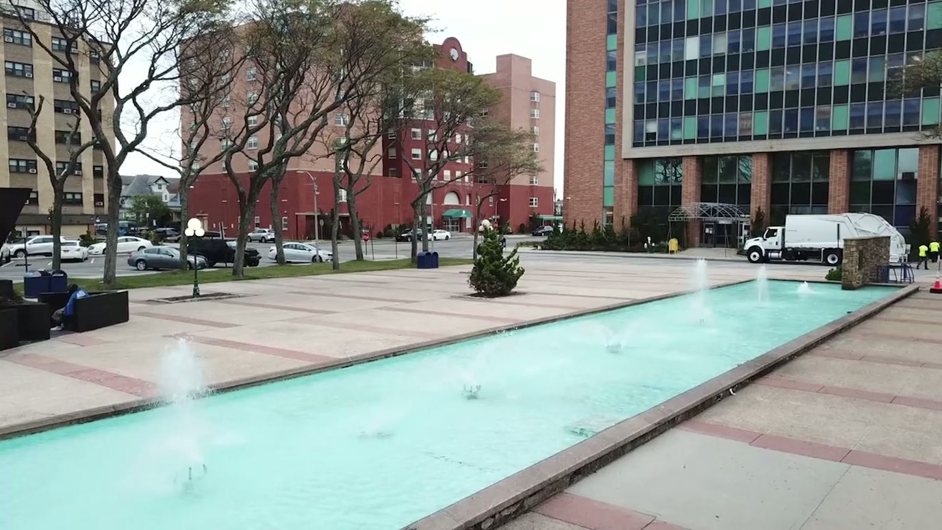Outdoor courtyard with a fountain and surrounding trees
