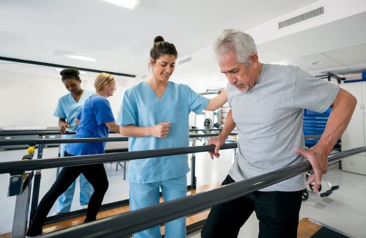 Therapist assisting a senior during rehabilitation