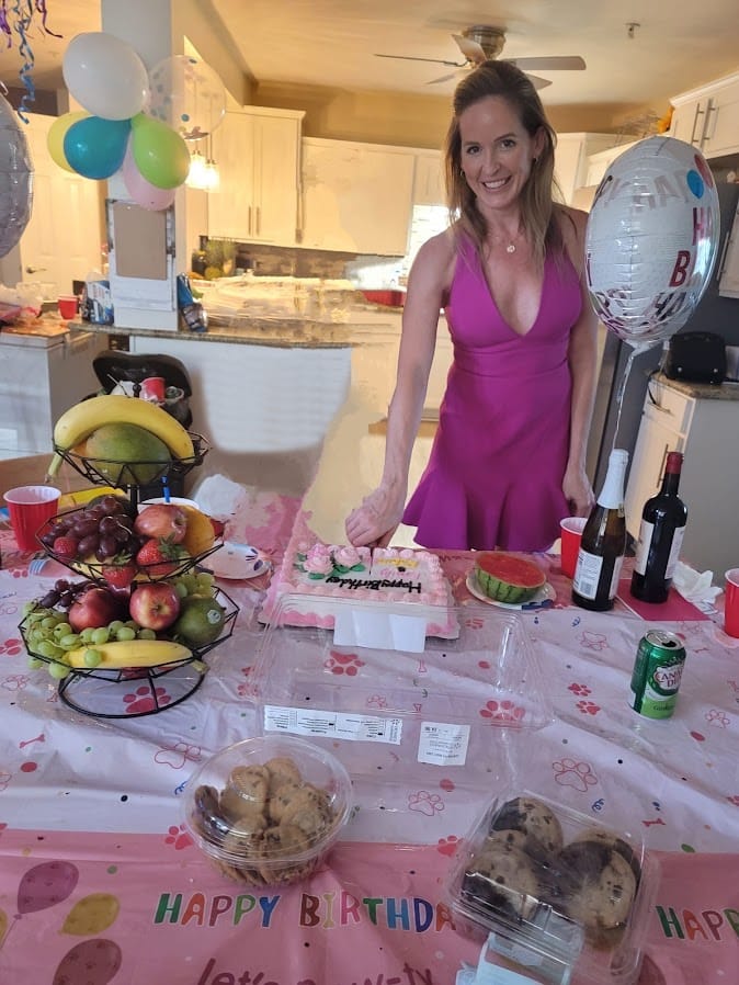 A woman celebrating a birthday at a decorated table