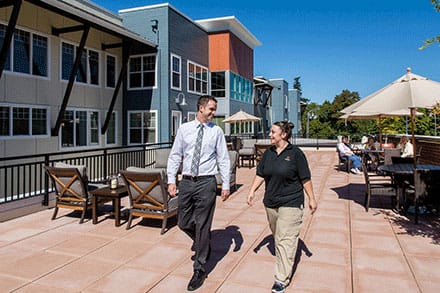 Marquis Tualatin Assisted Living, Assisted Living in Tualatin, OR — Staff members walking on a sunny outdoor patio
