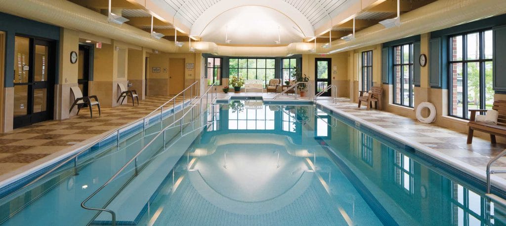 Indoor swimming pool area with seating