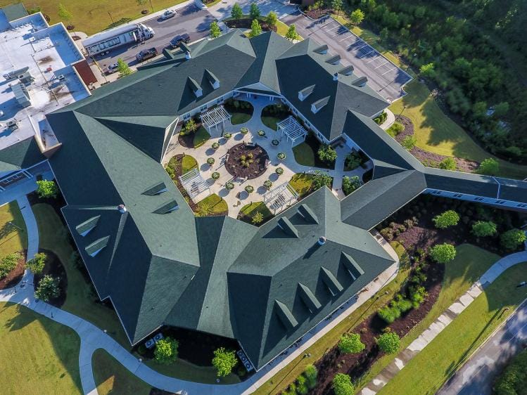 Aerial view of a senior living facility with landscaped gardens
