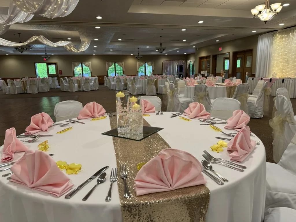 Elegant banquet setup with pink napkins and centerpieces