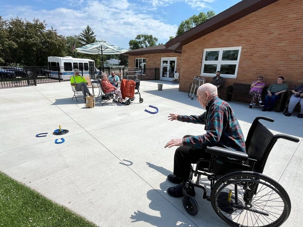 Residents enjoying a game of horseshoes outside
