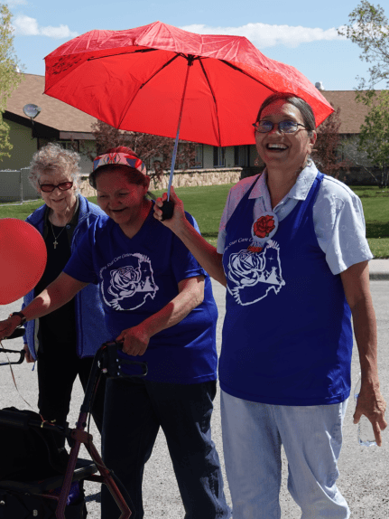 Residents enjoying a community event outdoors with umbrellas