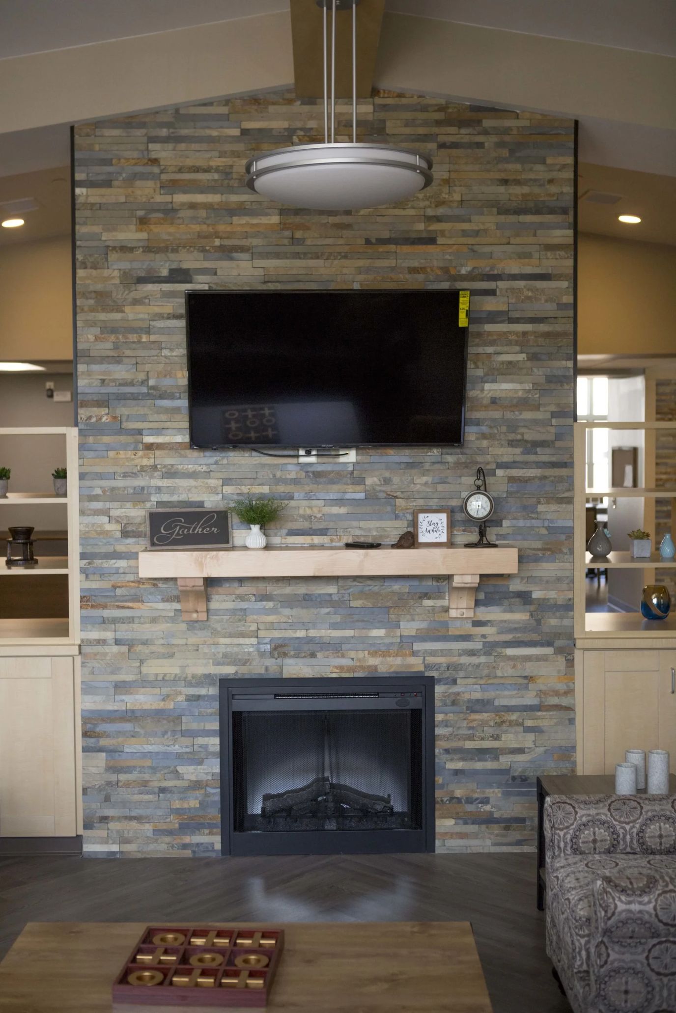 Cozy common area with a fireplace and TV