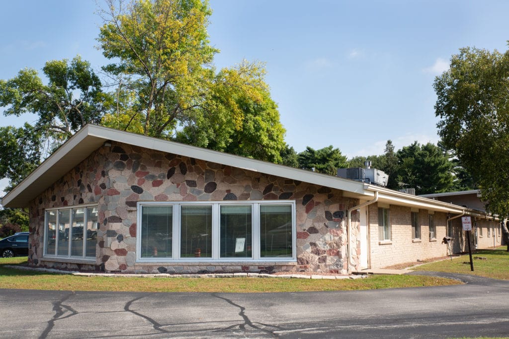 Exterior view of a facility building with landscaped area