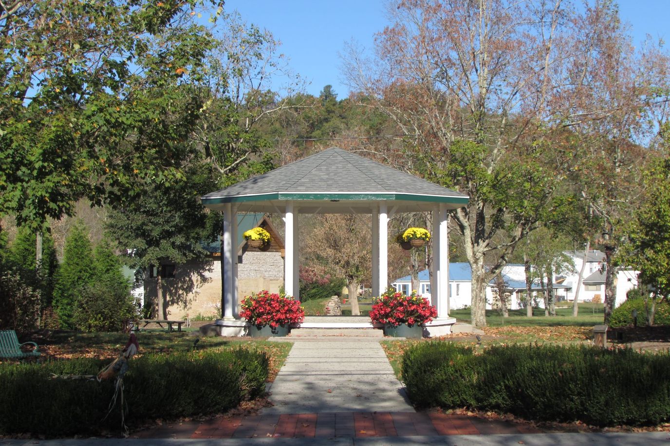 Gazebo surrounded by colorful flowers in a garden