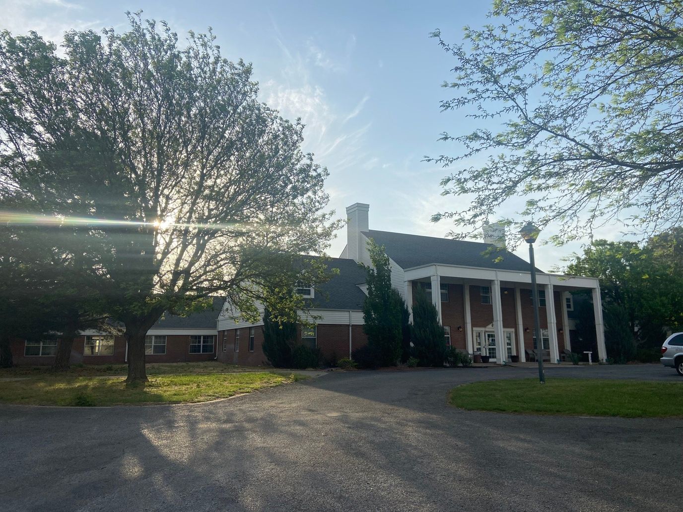 Exterior view of a senior living facility surrounded by trees