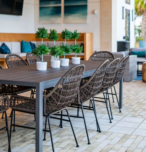 Outdoor dining area with modern seating and greenery