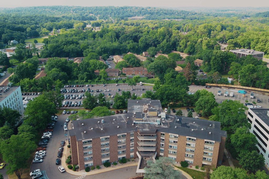 Aerial view of a senior living facility surrounded by greenery