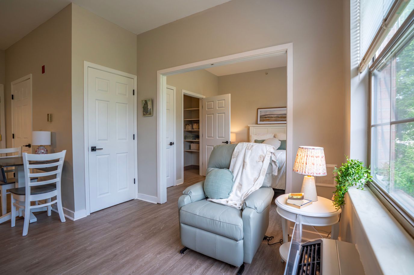 Cozy resident room with a relaxing chair and natural light