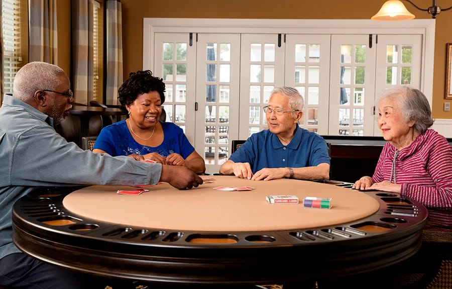 Residents enjoying a card game in a common area