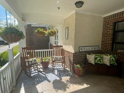 Welcoming porch with rocking chairs and potted plants