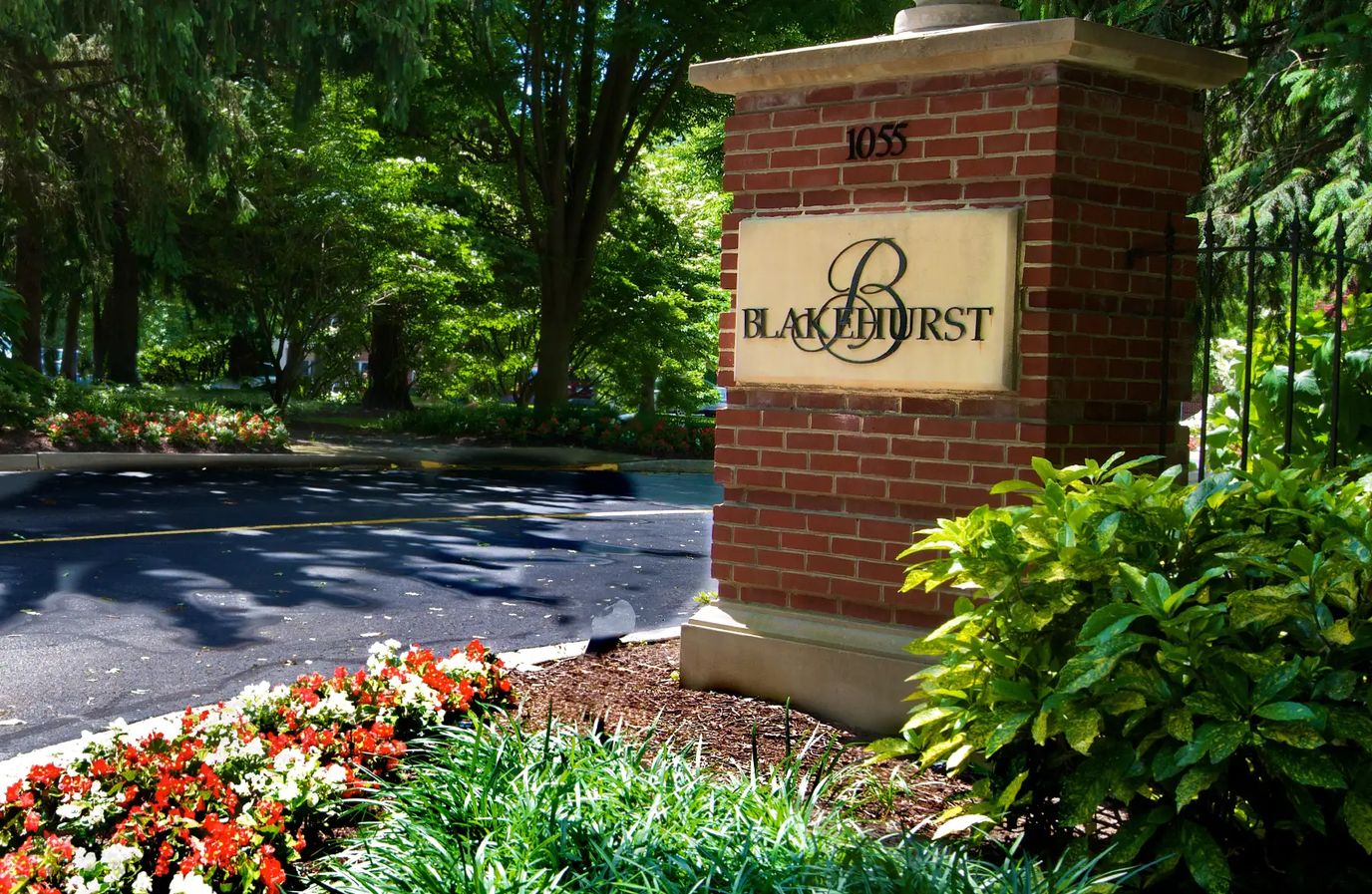 Blakehurst facility entrance sign amidst greenery.