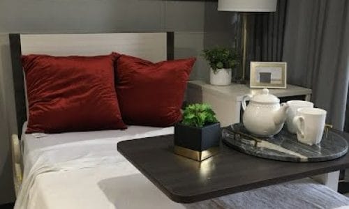 Cozy bedroom setup with a bedside table and tea set