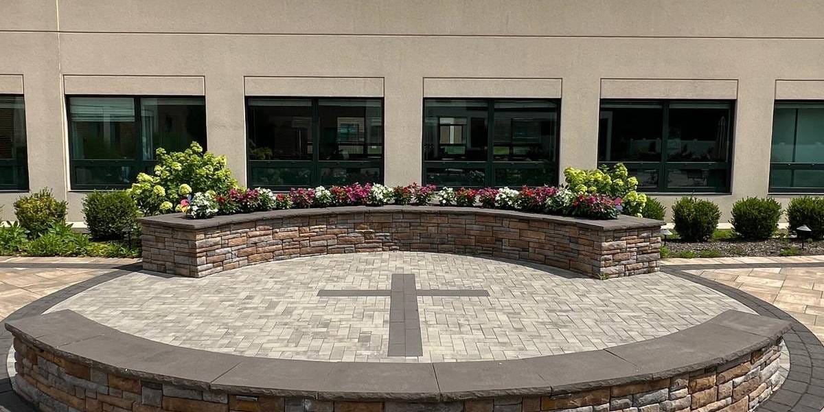 Complete Care At St Vincents Llc, Nursing Home in Cedar Grove, NJ — Outdoor seating area with floral arrangements and cross