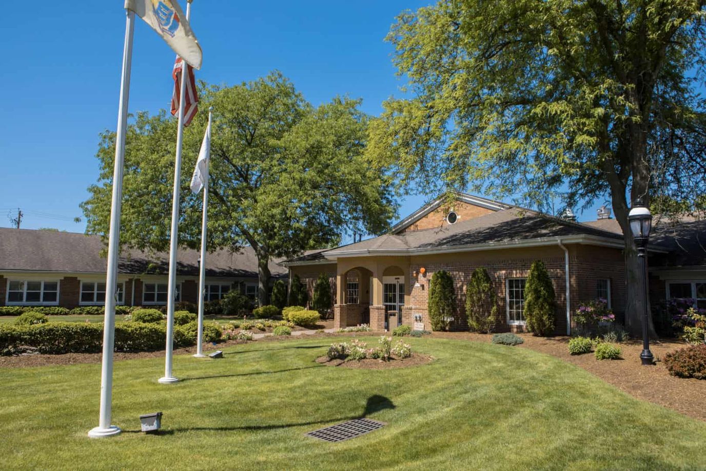 Exterior view of nursing home entrance and garden.