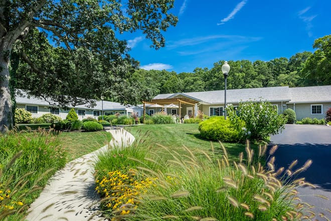 Exterior view of the facility with gardens and pathway