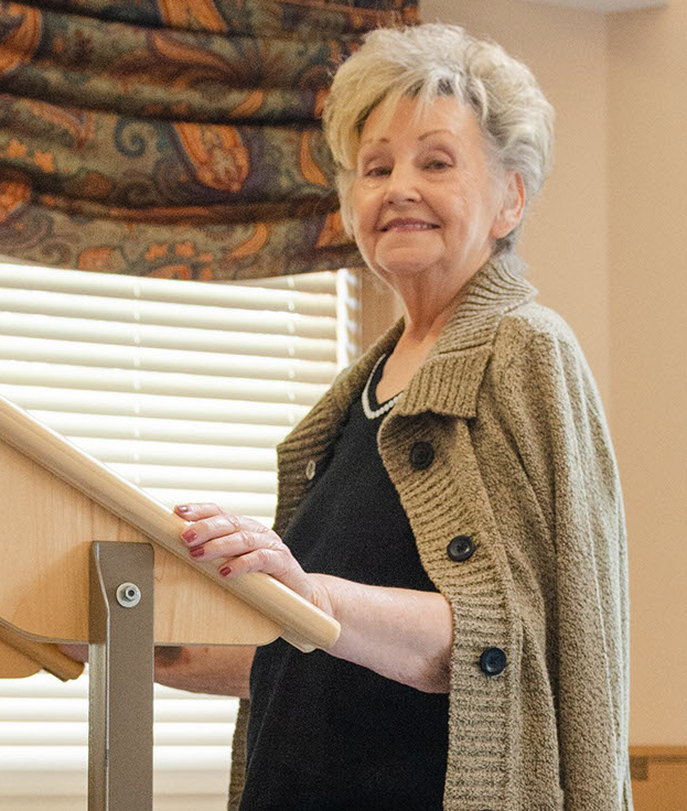 Smiling resident at a podium in a common area