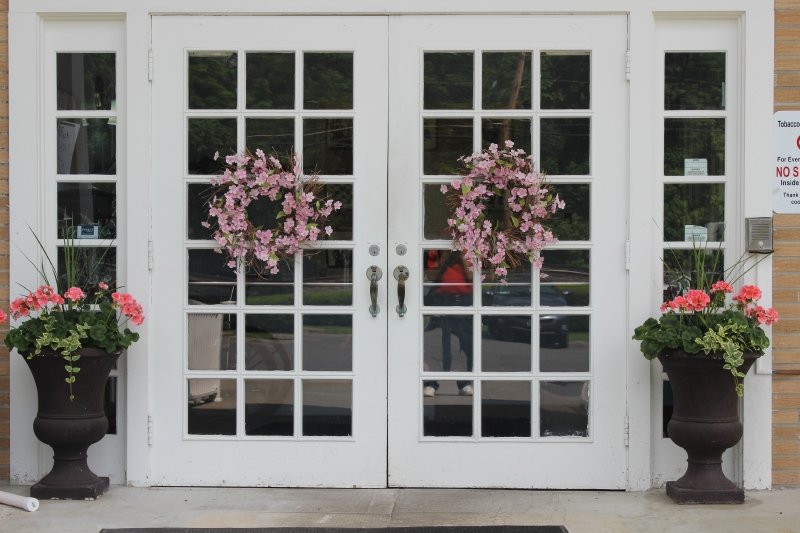 Main entrance doors adorned with flower arrangements