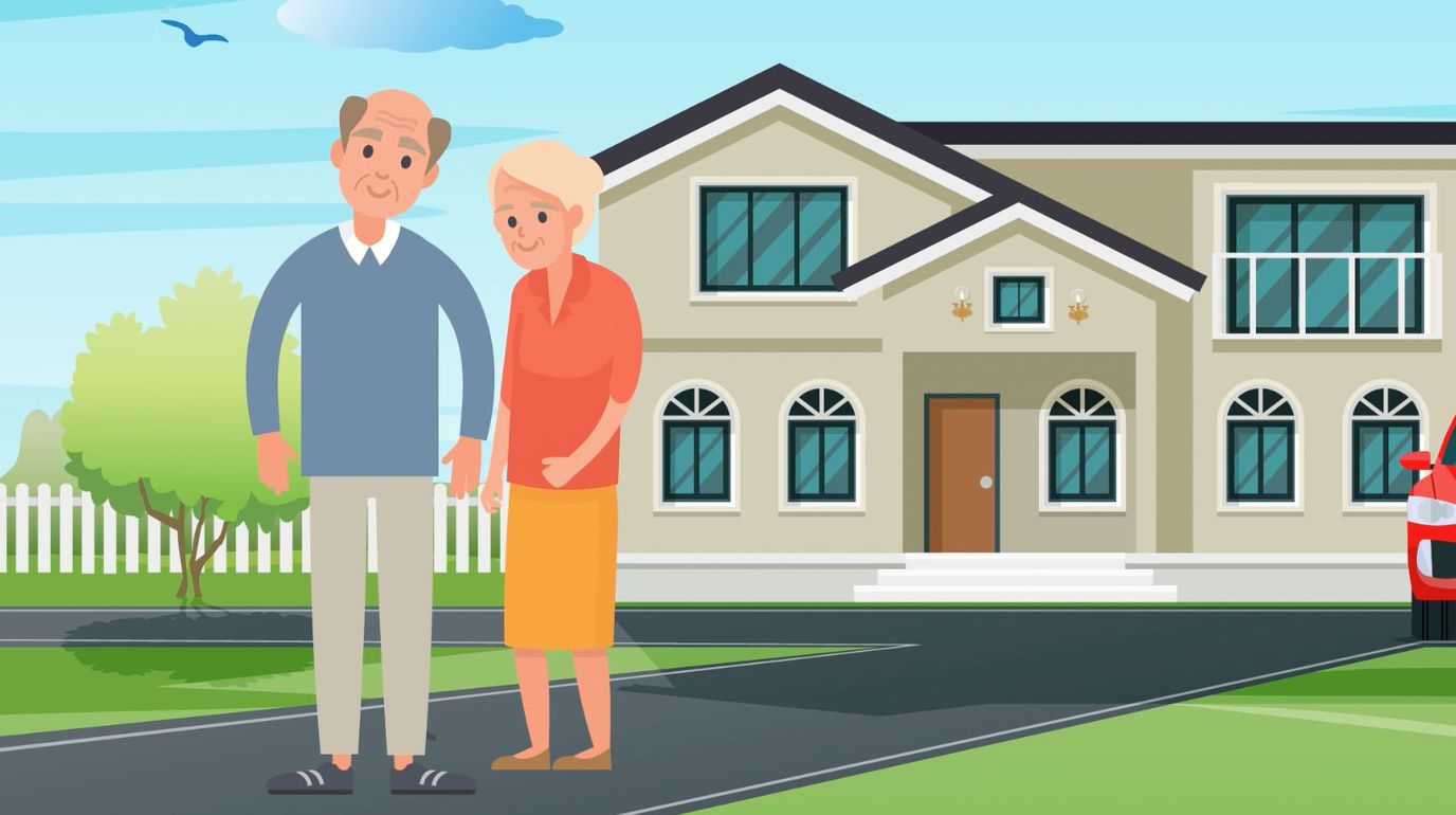 Two seniors standing in front of a house