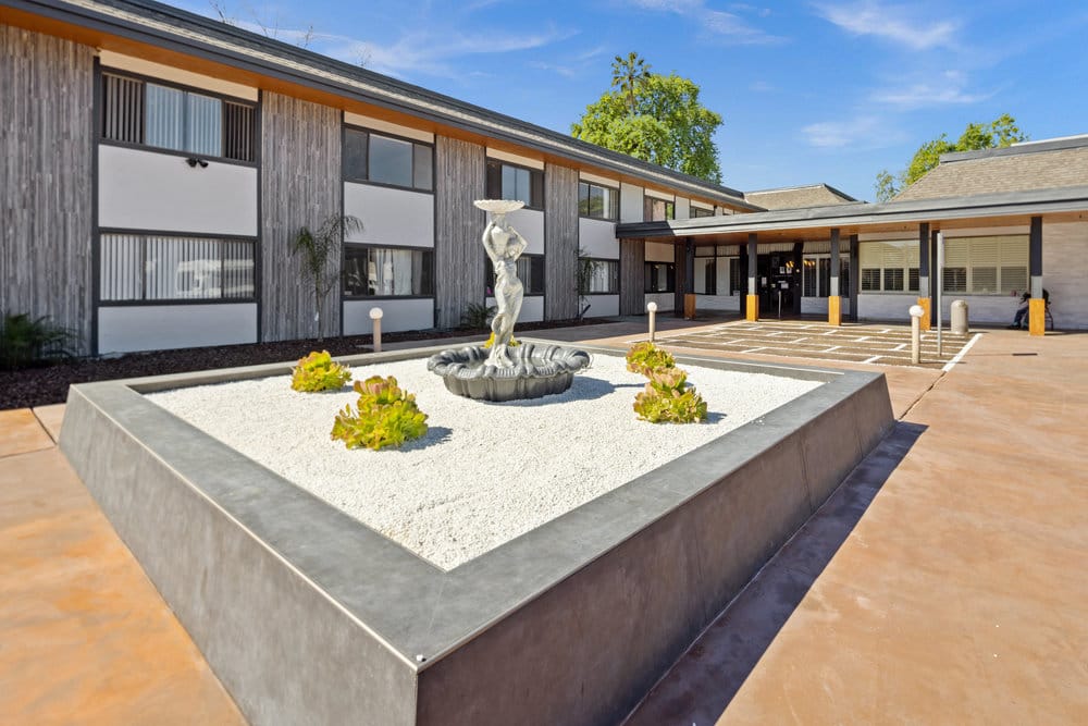 Outdoor area with a fountain and landscaped garden.