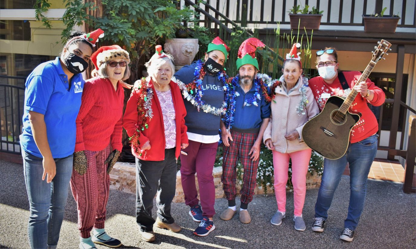 Residents and staff celebrating with holiday attire