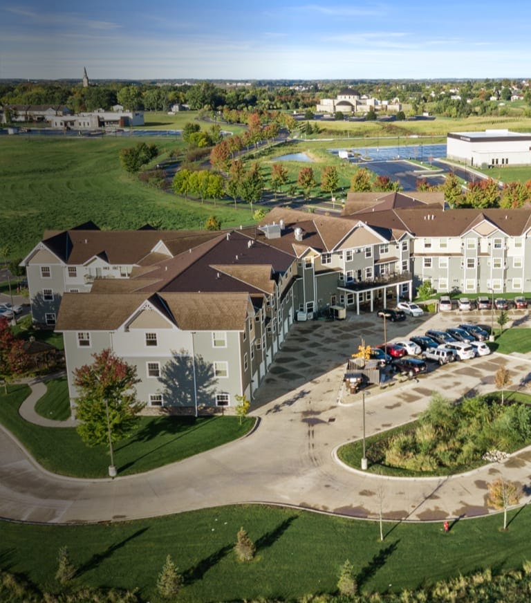 Aerial view of the assisted living facility with landscaped grounds