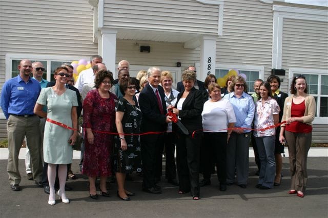 Facility staff and community members at a ribbon-cutting ceremony