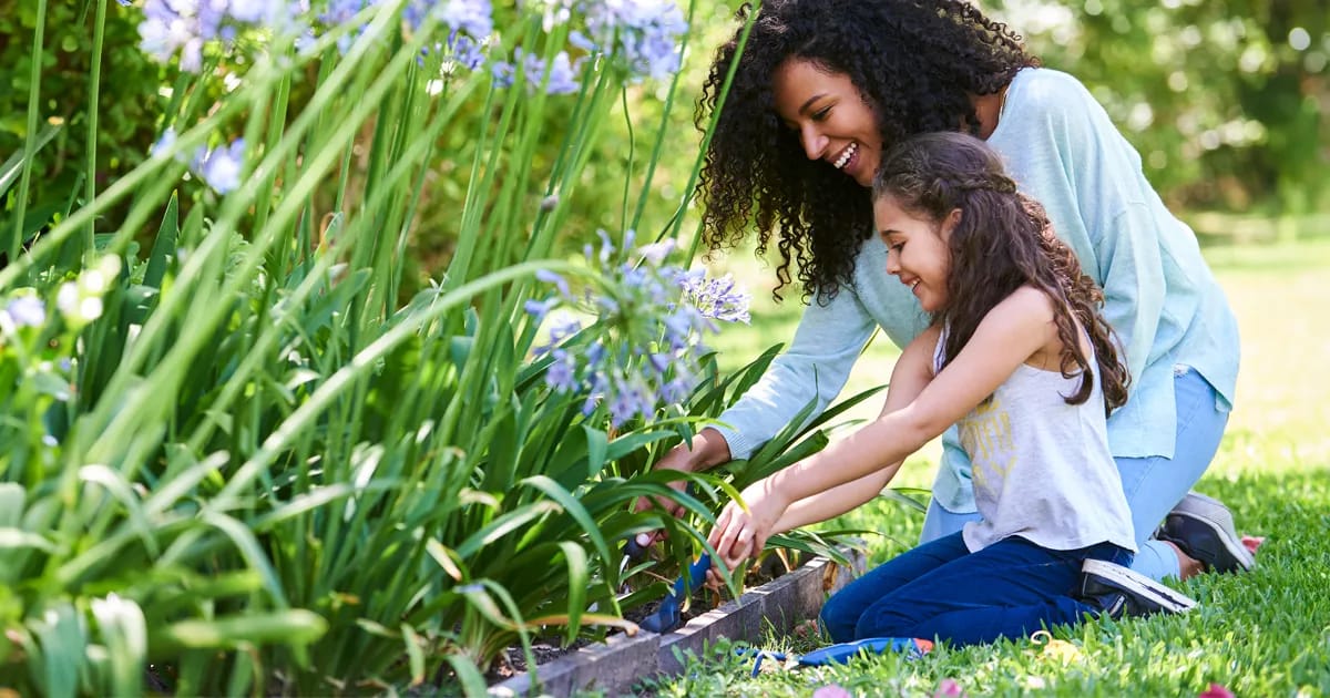 Woman and girl gardening together.