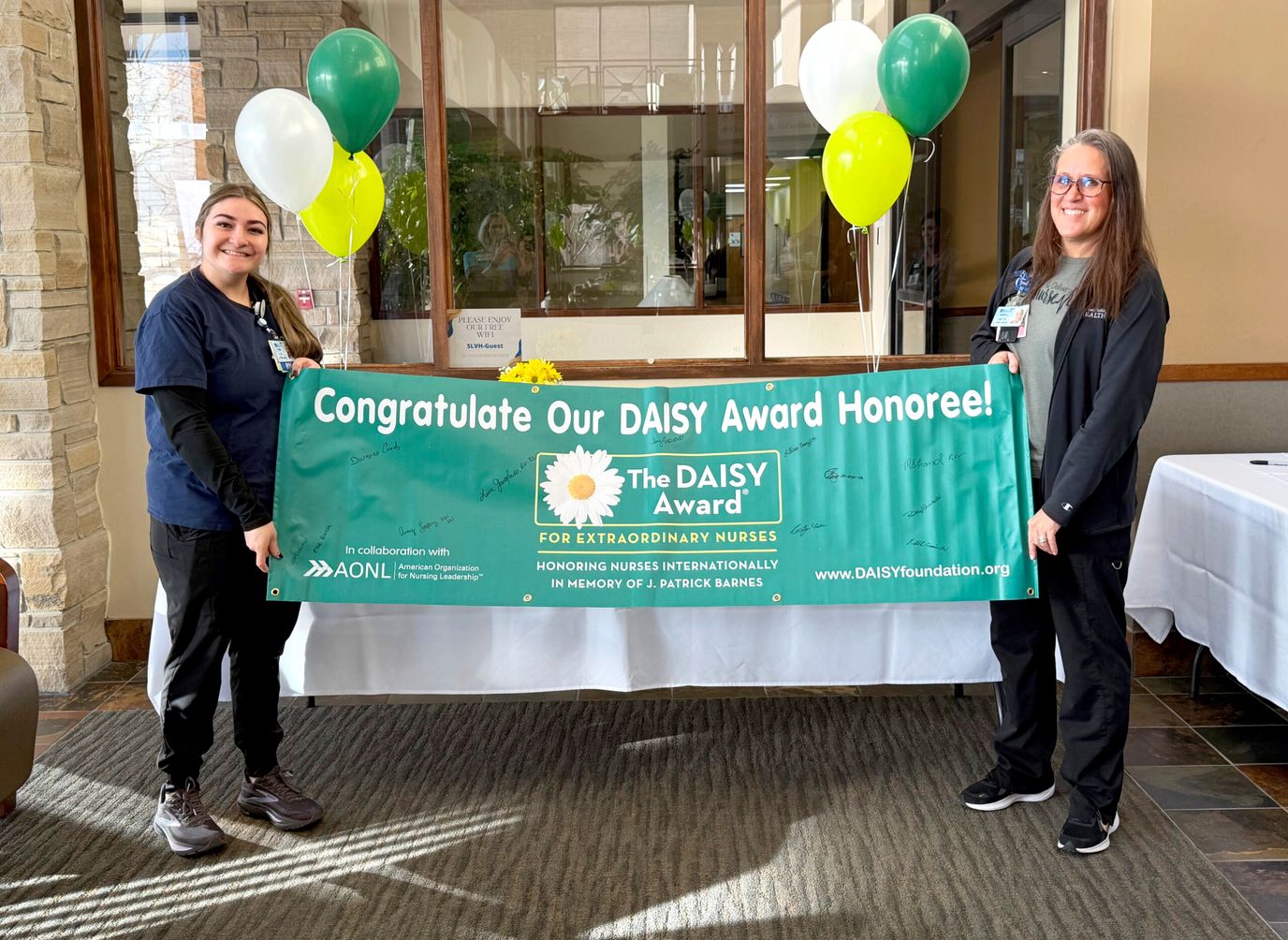 Staff celebrating a DAISY Award in a common area