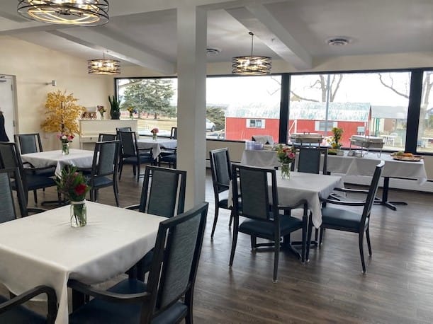 Bright dining room with tables set for meals