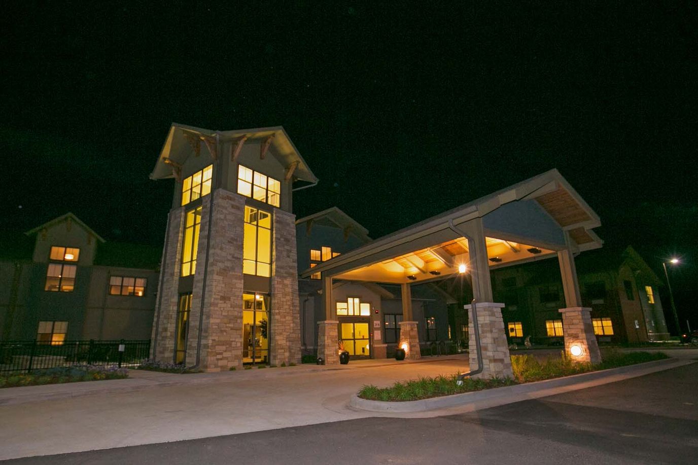 Exterior view of a senior living facility at night