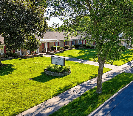 Exterior view of assisted living facility and garden.