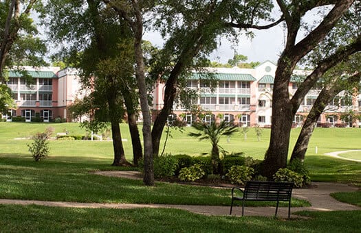 View of a landscaped outdoor area with the facility in the background