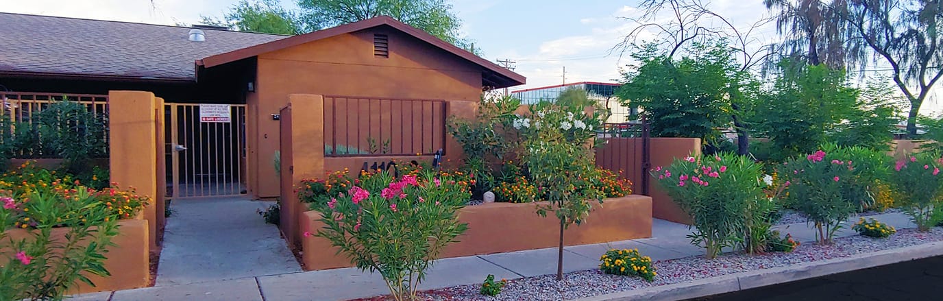 Exterior view of The Grove Assisted Living entrance with flowers.