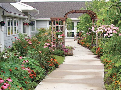 Beautiful garden path with flowers and seating area