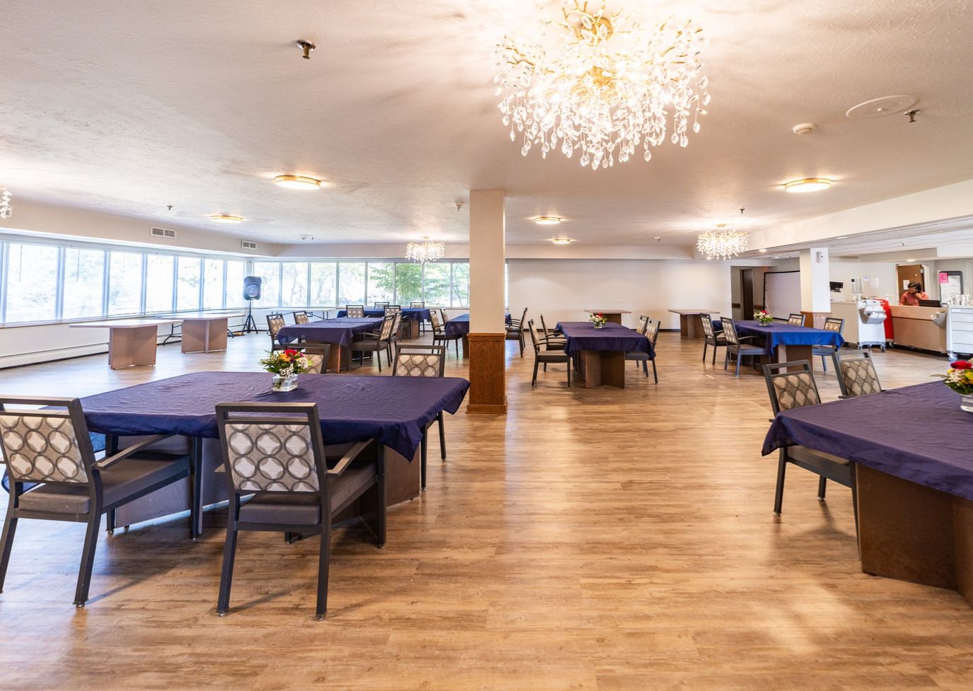 Dining room with tables set for meals and decorative centerpieces.