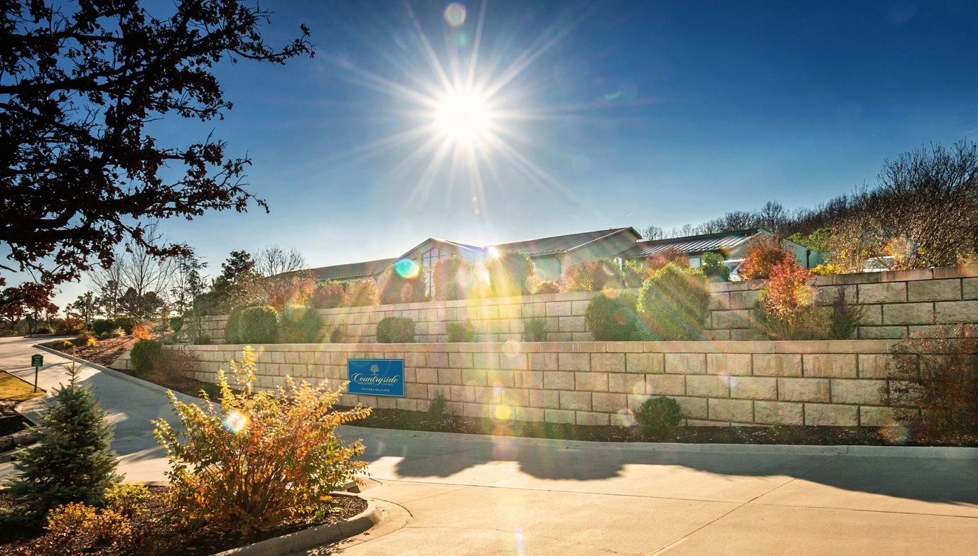 Sunny view of the facility entrance and landscape.