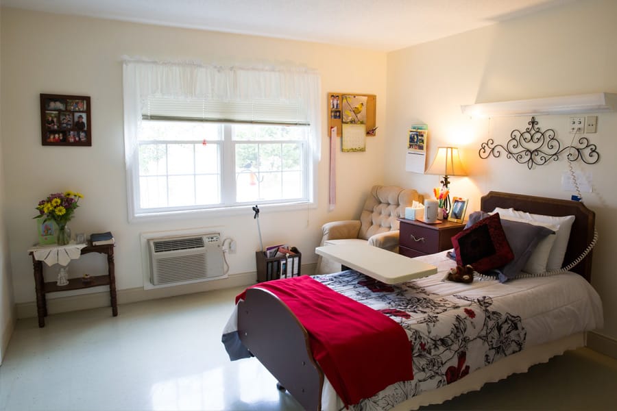 Cozy resident room with bed and armchair