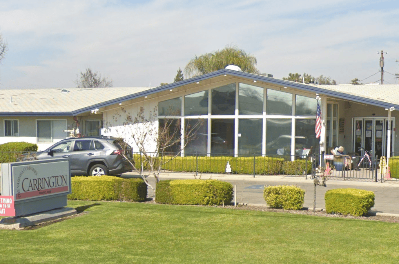 Exterior view of Carrington facility with sign and landscaping